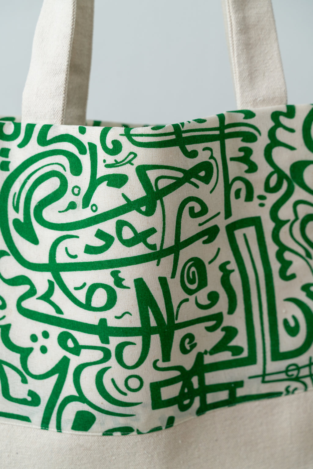 Green Calligraphy Tote – front panel and handles of the tote, showing the full calligraphy design, by Noha Fathy