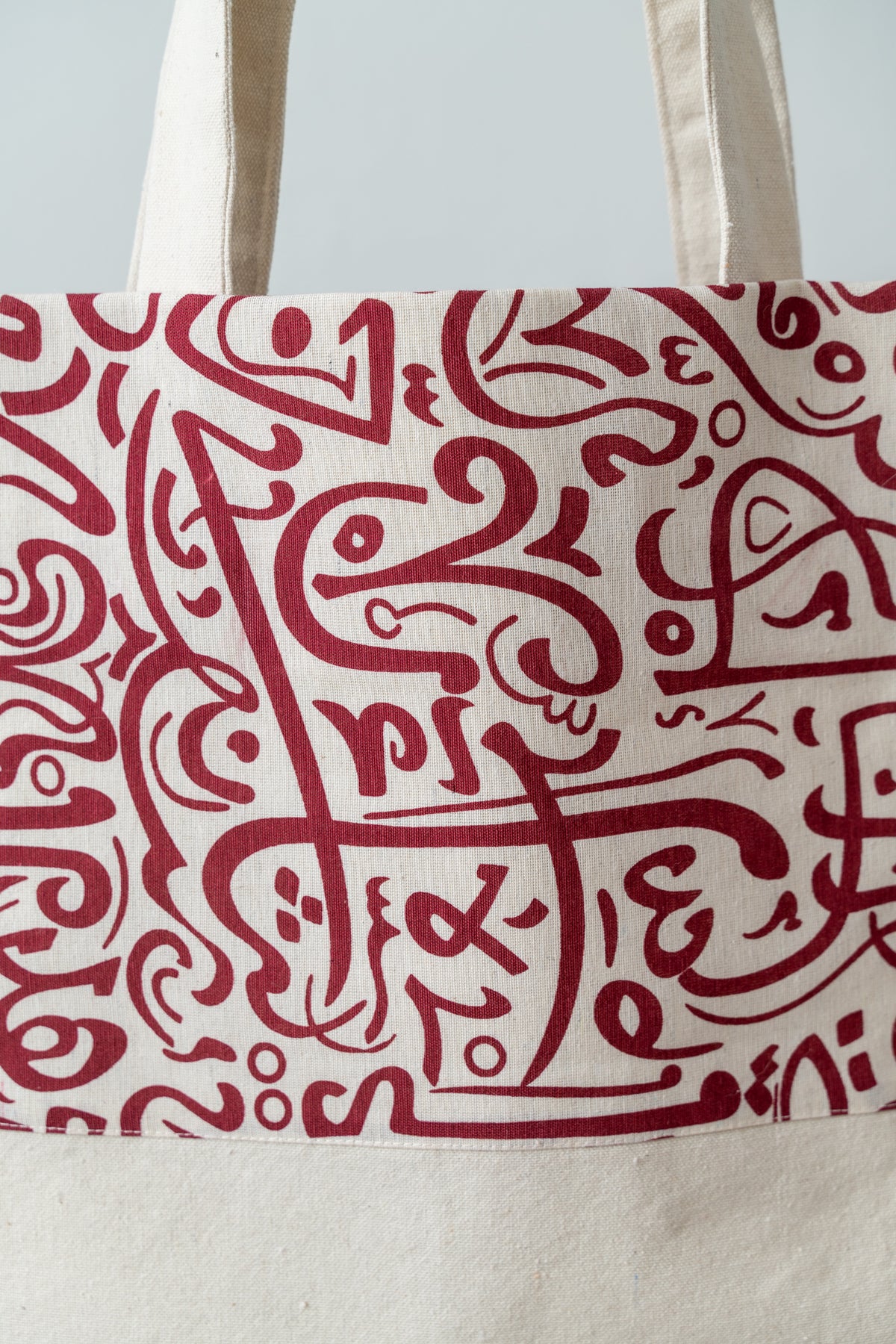 Red Calligraphy Tote – front panel and handles of the tote, showing the full calligraphy design, by Noha Fathy