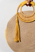 The Soleil Bag – round spiral jute bag with a bamboo ring handle and mustard tassel, handmade by Noha Fathy